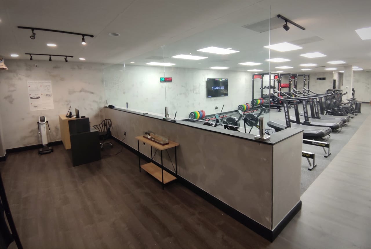 The front desk at Ludus Actius, with the training floor behind it